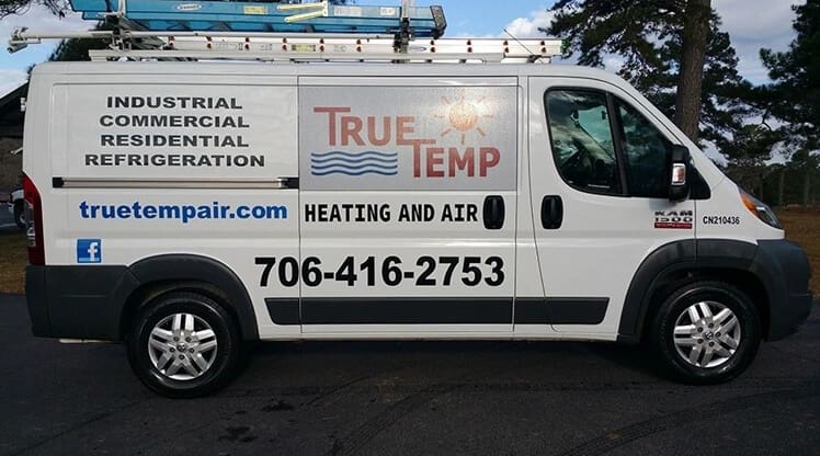 A white truck with the logo of true temp with a sun on it.