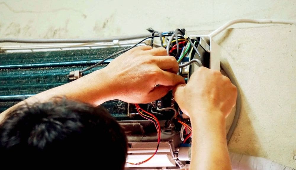A man working on a circuit ad wired barehand